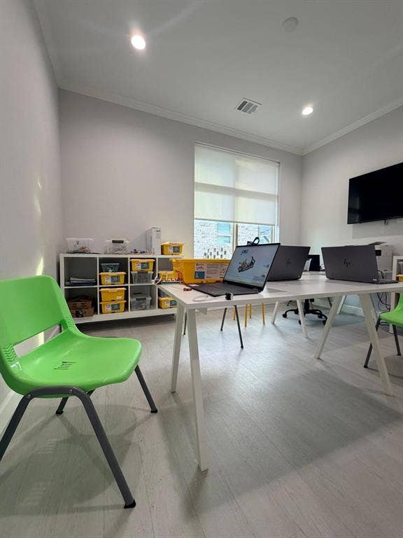 Neutral interior featuring wood-finish flooring, recessed lighting, and a window with a retractable roller shade