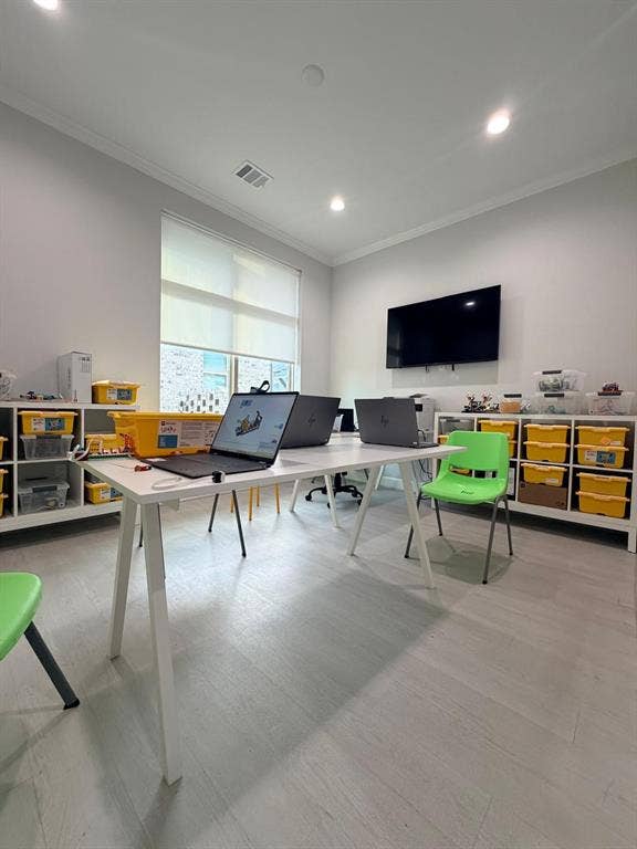 Room featuring wood-finish flooring, recessed lighting, and wall-mounted television
