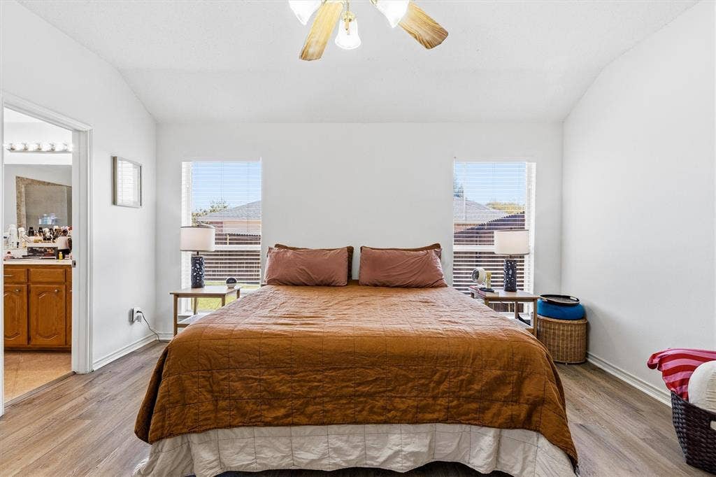 409 Danmire Drive, Murphy, TX 75094 The primary bedroom features dual windows, raised ceilings, ceiling fan and updated flooring