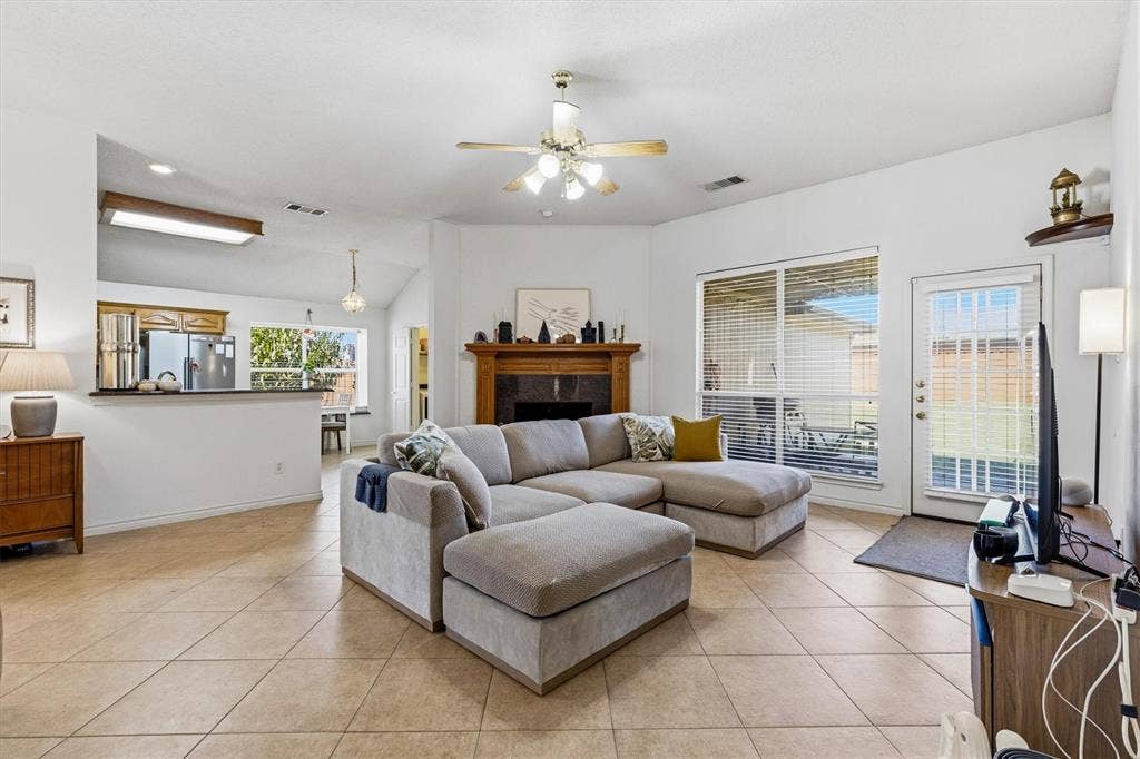 409 Danmire Drive, Murphy, TX 75094 The open concept living room with access to the backyard