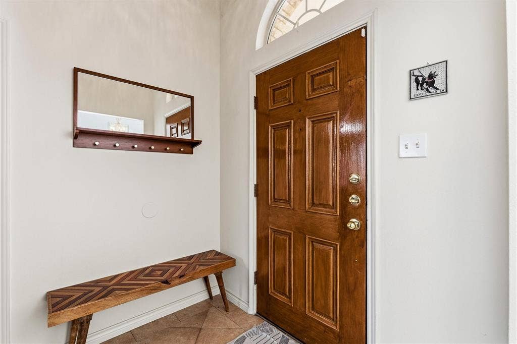 409 Danmire Drive, Murphy, TX 75094 Well lit front entry way with coat closet and open to the dining room