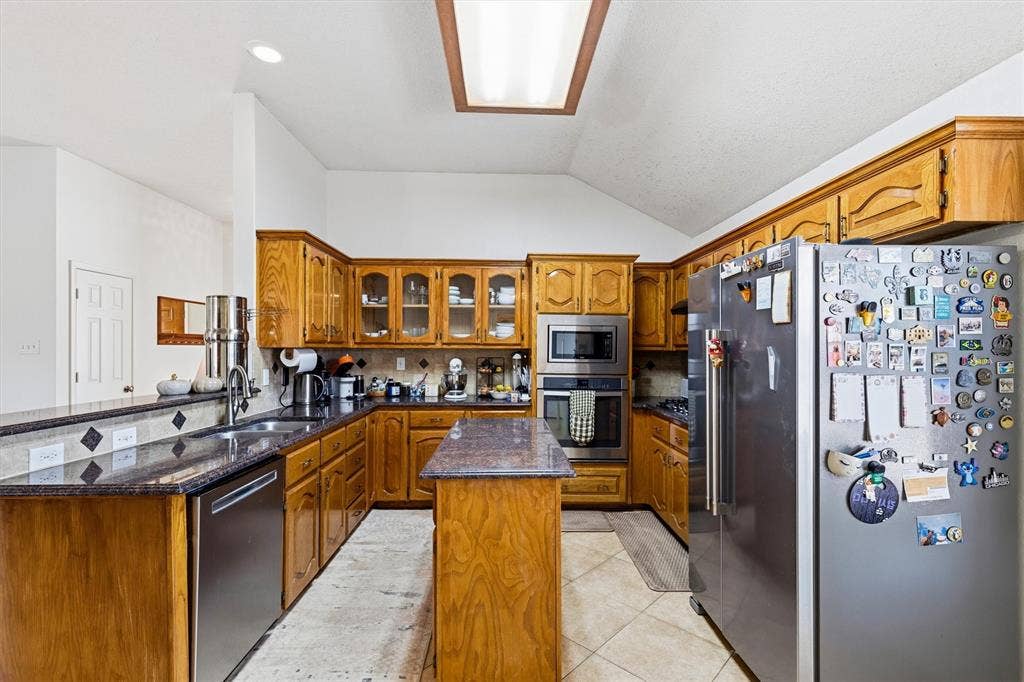 409 Danmire Drive, Murphy, TX 75094 Kitchen features SS built in stacked microwave and oven and drop in gas range and sichwasher