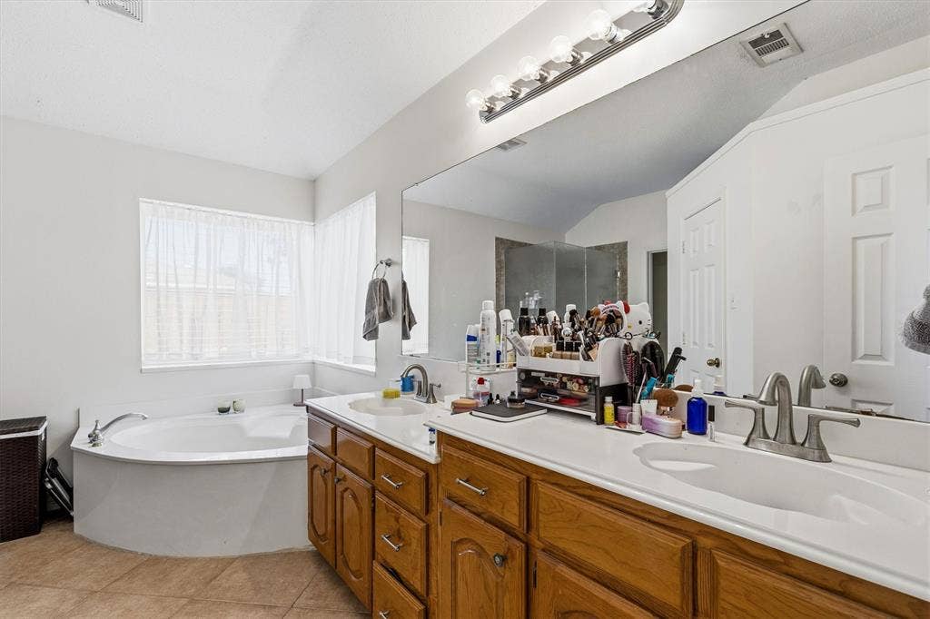 409 Danmire Drive, Murphy, TX 75094 Primary bath features dual sinks, garden tub