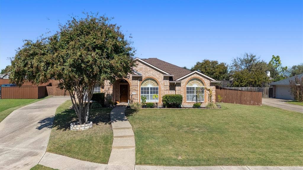 409 Danmire Drive, Murphy, TX 75094 Situated on an oversized lot with an extended driveway