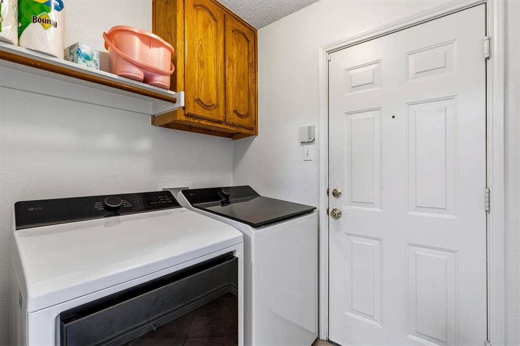 409 Danmire Drive, Murphy, TX 75094 the utility room with built in cabinet and FS WD connections and access to the garage