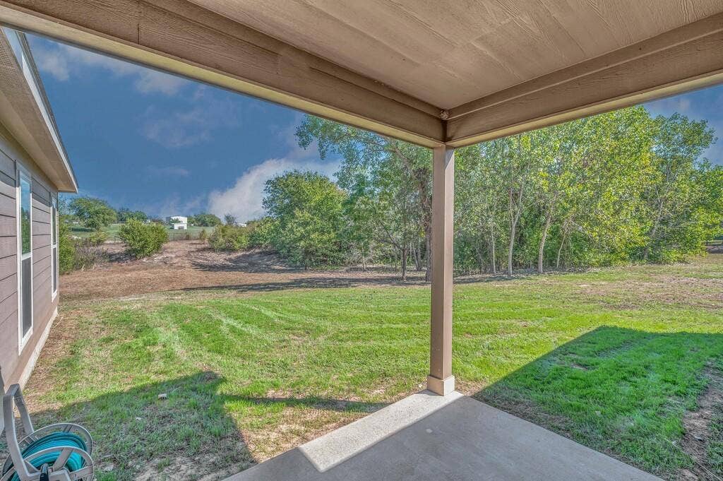310 Milky Way, Bruceville, TX 76630 Back covered patio and backyard