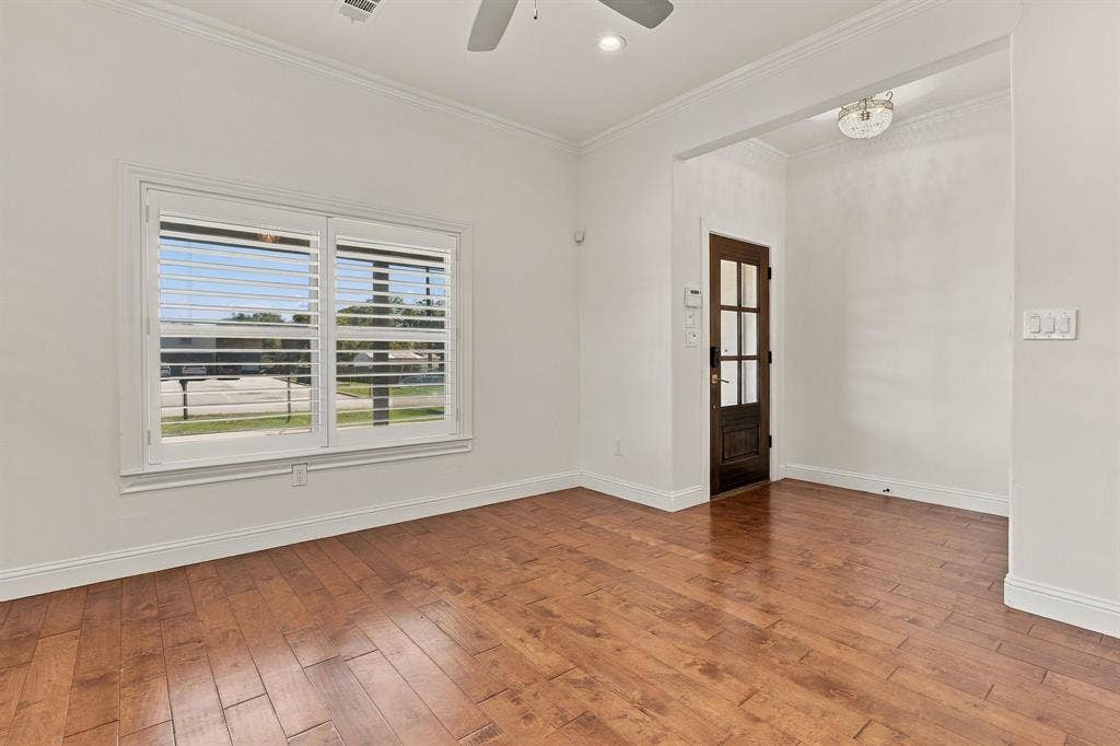 510 E Malone Street, Celina, TX 75009 Interior space featuring wood-finish flooring, white plantation shutters, crown molding, a ceiling fan, and a wood-framed glass-paneled entry door