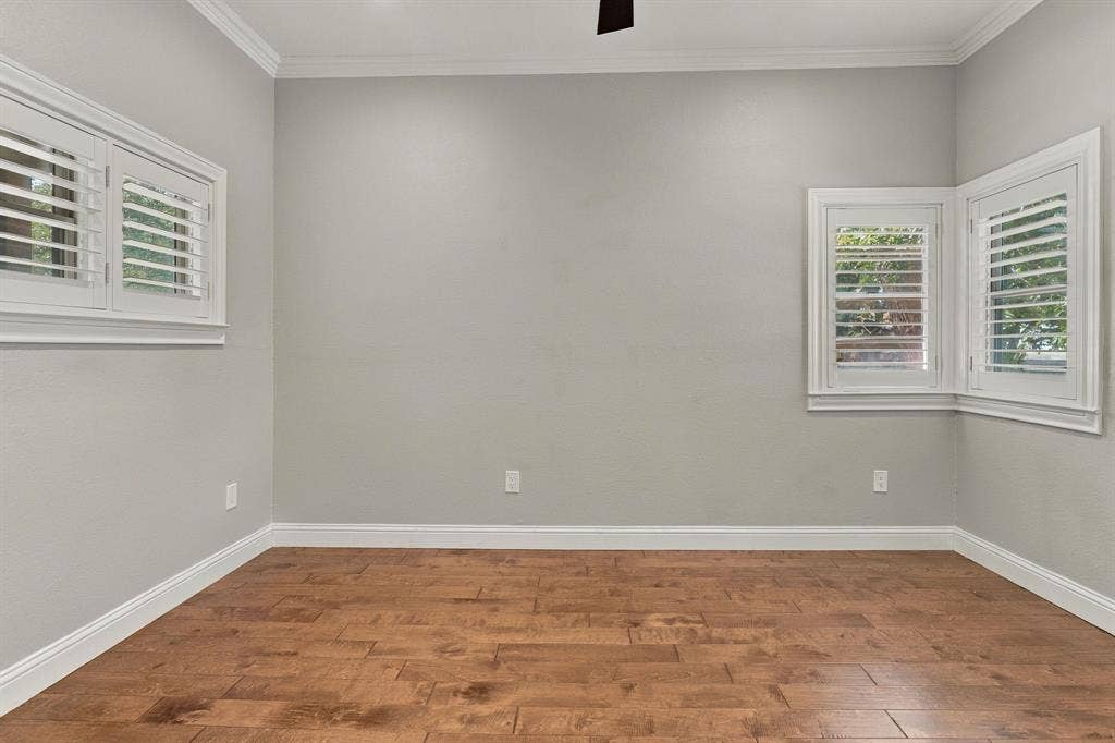 510 E Malone Street, Celina, TX 75009 Wood-finish flooring, interior window shutters, neutral wall paint, crown molding, and a bay window configuration
