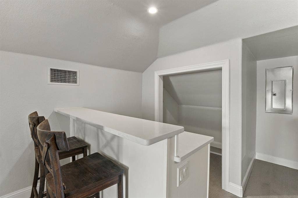 510 E Malone Street, Celina, TX 75009 Built-in breakfast bar featuring a solid-surface countertop and recessed ceiling lighting