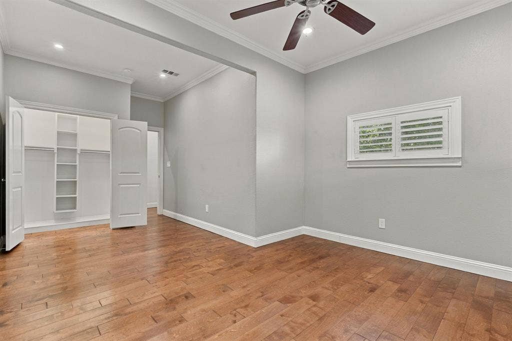 510 E Malone Street, Celina, TX 75009 Room featuring wood-finish flooring, recessed ceiling lighting, a multi-blade ceiling fan, and a walk-in closet with built-in shelving
