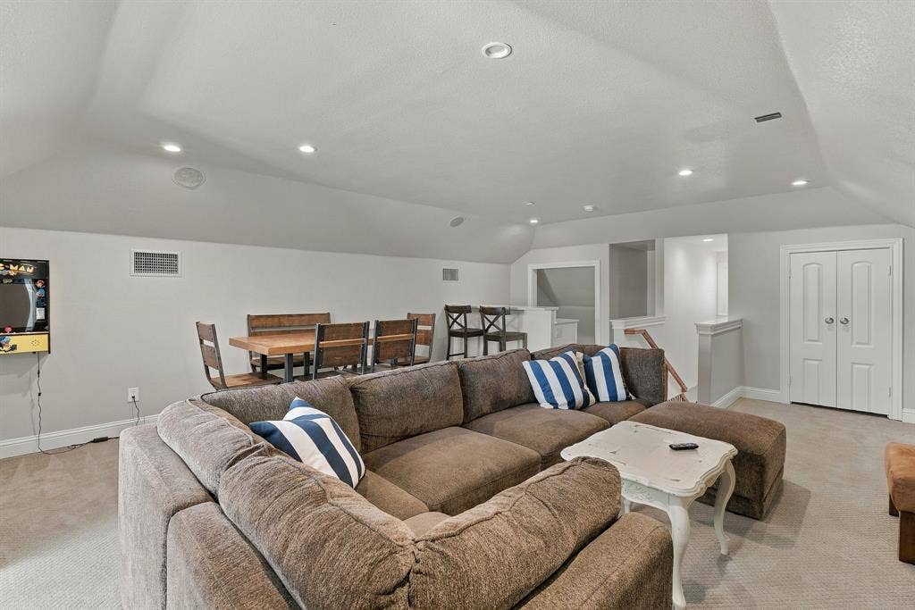 510 E Malone Street, Celina, TX 75009 Expansive room featuring vaulted ceilings, recessed lighting, neutral carpeting, and white dual-panel doors