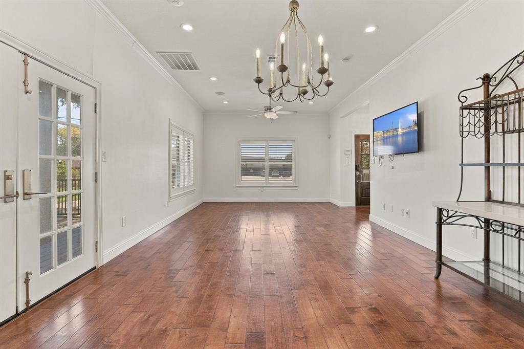 510 E Malone Street, Celina, TX 75009 Open living area featuring wood-finish flooring, crown molding, recessed lighting, a chandelier, and double French doors with glass panes
