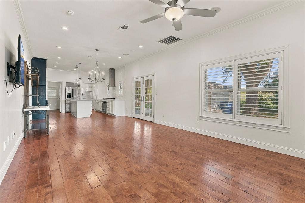 510 E Malone Street, Celina, TX 75009 Open-concept interior featuring wood-finish flooring, recessed lighting, a dual-lighted ceiling fan, plantation shutters, and glass-paned French doors