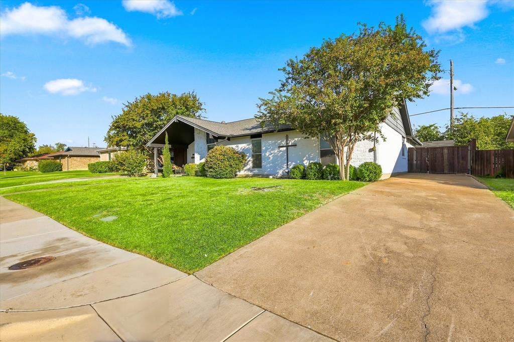 2117 Northmoor Drive, Carrollton, TX 75006 Access the garage in the back of the house from the long driveway on the side of the house