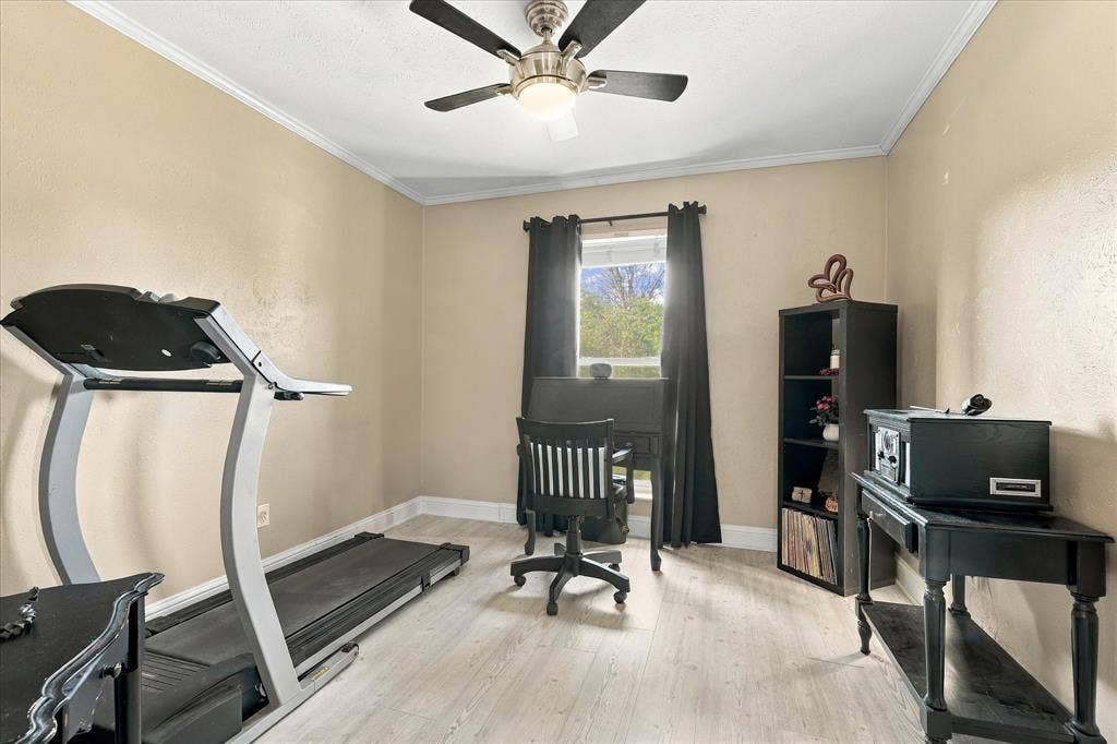 2117 Northmoor Drive, Carrollton, TX 75006 Room featuring wood-finish flooring, a central ceiling fan with integrated lighting, and a window with neutral wall finishes