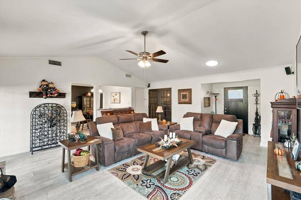 2117 Northmoor Drive, Carrollton, TX 75006 Vaulted ceilings, wood-finish flooring, ceiling fan with integrated lighting, skylight, and glass-paneled interior French doors