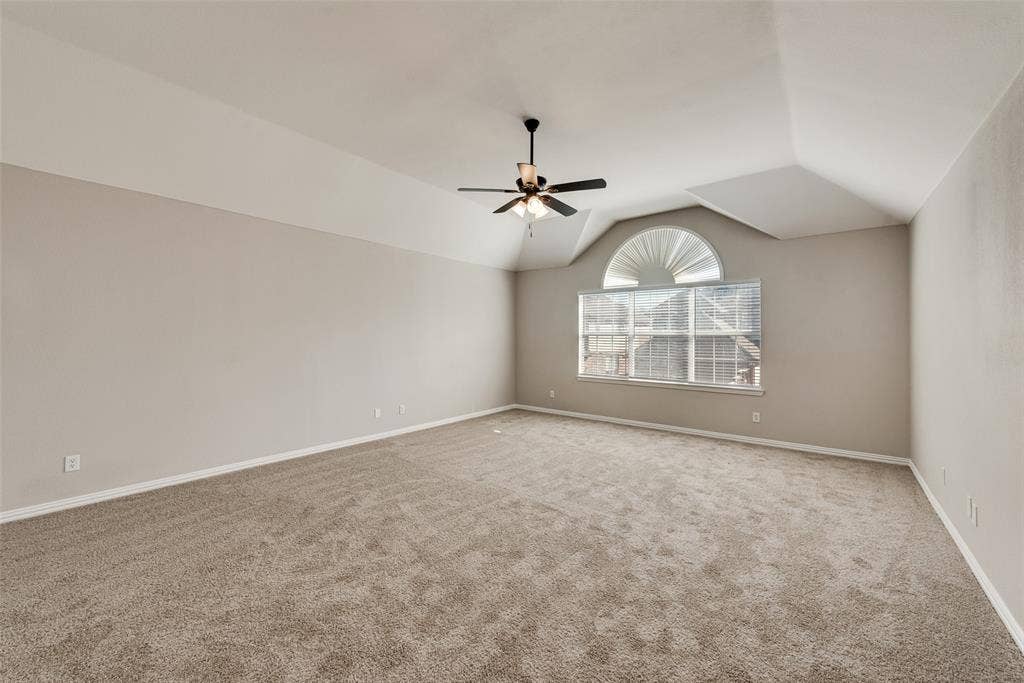2017 Lunenburg Drive, Allen, TX 75013 Vaulted ceilings, neutral carpeting, and a multi-light ceiling fan