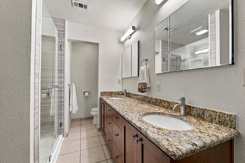 1508 Heidi Drive, Plano, TX 75025 Two sinks, granite counter tops - custom cabinets - double glass mirrors with hidden medicine cabinetsCommode behind the wall with more cabinets