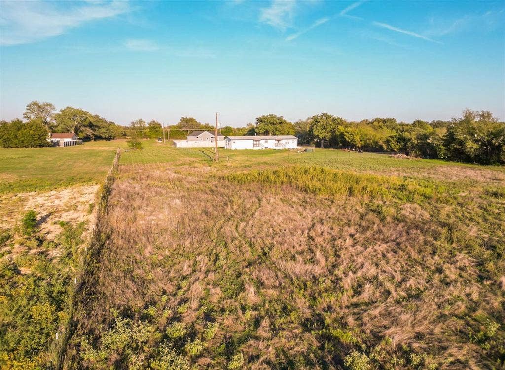 3659 N Katy Road, Ross, TX 76640 Expansive acreage featuring open fields, peripheral mature trees, and wire perimeter fencing