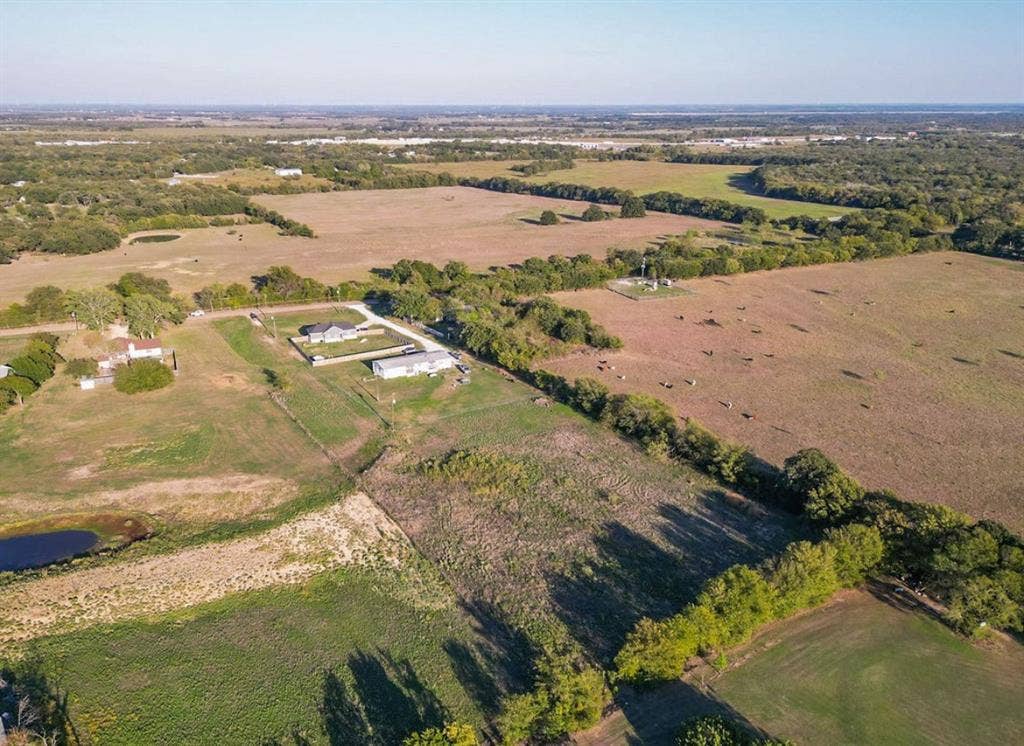 3659 N Katy Road, Ross, TX 76640 Expansive acreage featuring open pasture land, established tree lines, and a pond