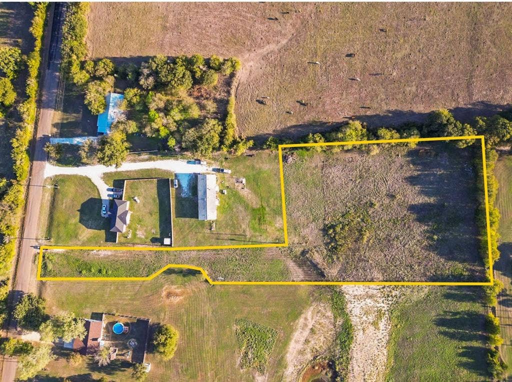 3659 N Katy Road, Ross, TX 76640 Aerial perspective of acreage featuring open grass pasture, boundary perimeter markers, and mature tree lines