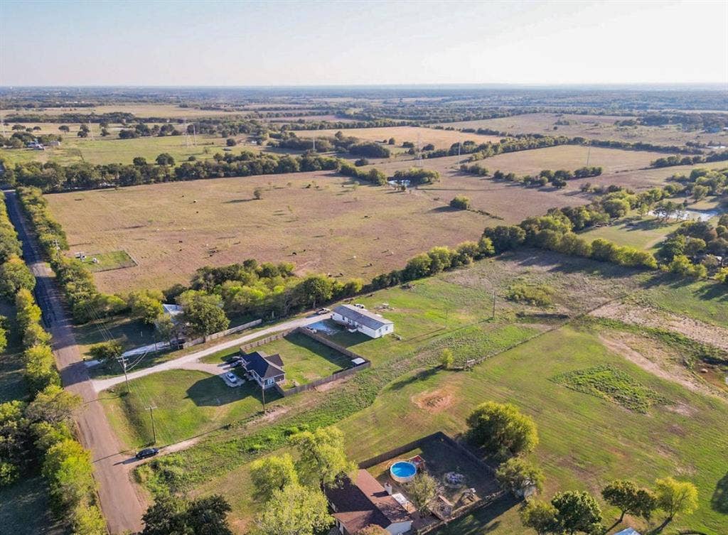 3659 N Katy Road, Ross, TX 76640 Aerial perspective featuring extensive acreage, mature trees, open pastureland, and established boundary fencing