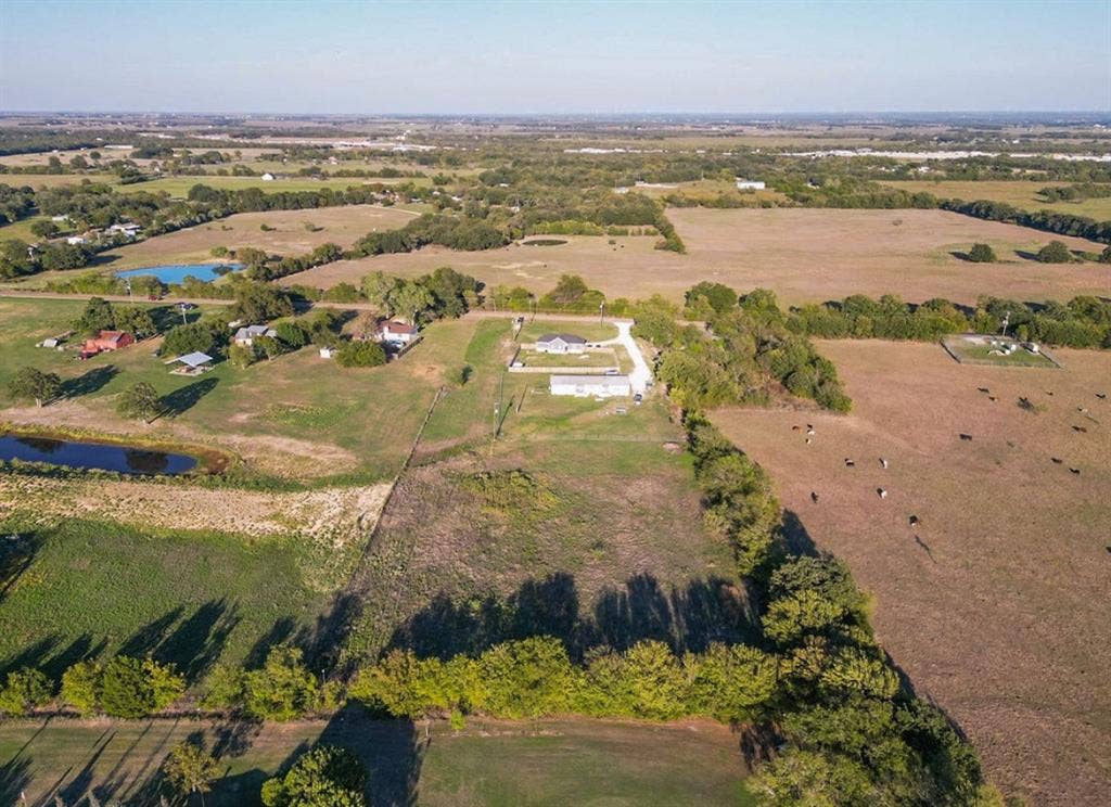 3659 N Katy Road, Ross, TX 76640 Aerial perspective of expansive acreage featuring fenced perimeter, open pastures, and mature treelines