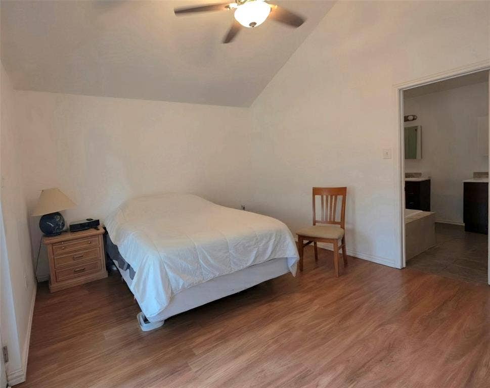 9436 Penny Lane, Irving, TX 75063 Room featuring vaulted ceiling, wood-finish flooring, and ceiling fan with integrated lighting