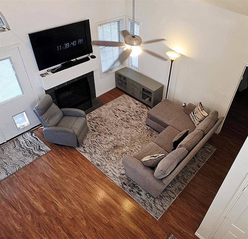 9436 Penny Lane, Irving, TX 75063 Vaulted ceilings, wood-finish flooring, and a stone-surround fireplace with a custom mantel