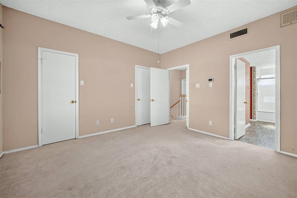 5859 Frankford Road, #1209, Dallas, TX 75252 Neutral wall tones, wall-to-wall carpeting, and a ceiling-mounted fan with integrated light fixture