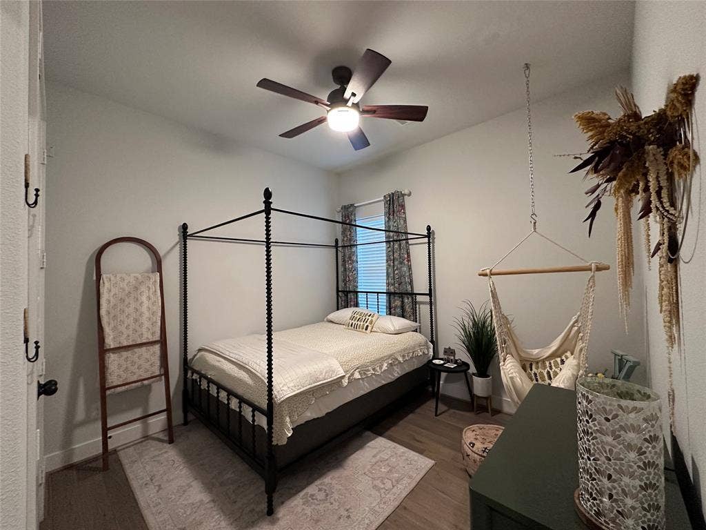2712 War Admiral Street, Celina, TX 75009 Room featuring wood-finish flooring, a ceiling fan with integrated lighting, and a window with neutral-toned hardware