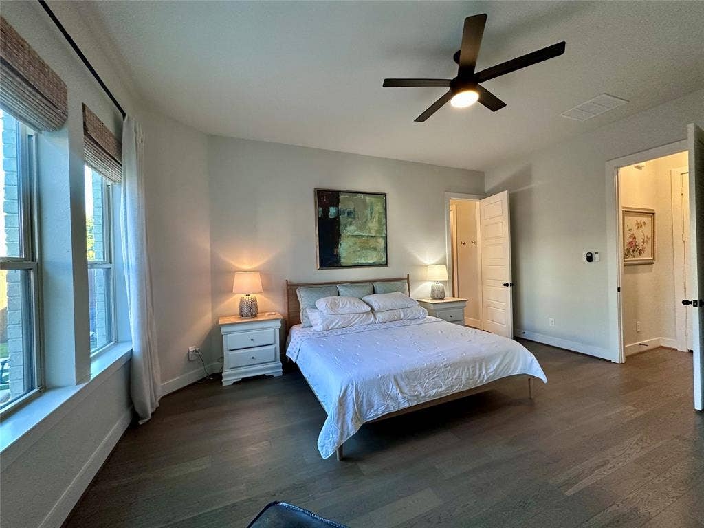 2712 War Admiral Street, Celina, TX 75009 Wood-finish flooring, multi-pane windows, and a matte black ceiling fan with integrated lighting