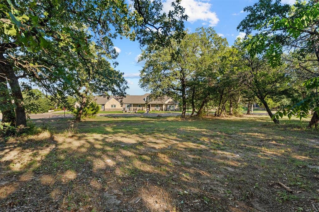 1027 Dominion Oaks Drive, China Spring, TX 76633 Expansive lot featuring mature hardwood trees