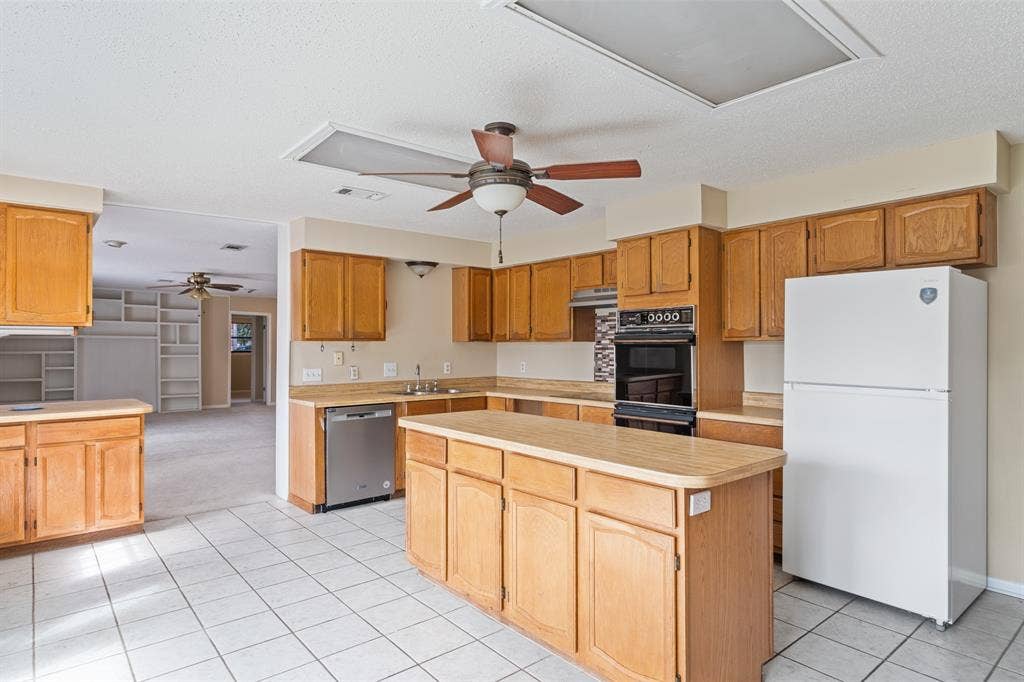 2729 Tanglewood Drive, Commerce, TX 75428 Lots of cabinets and an entire room behind the kitchen for storage!