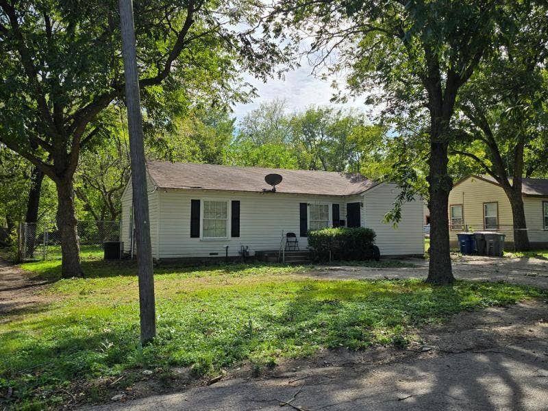530 Elston Drive, Dallas, TX 75232 Single-story residence featuring horizontal lap siding, dark shutter accents, and mature trees on a level lot