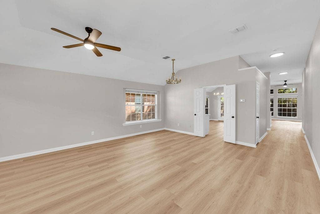 12109 Biloxi Drive, Frisco, TX 75035 Vaulted ceilings with recessed lighting, wood-finish flooring, multi-pane windows, and dual-swing doors