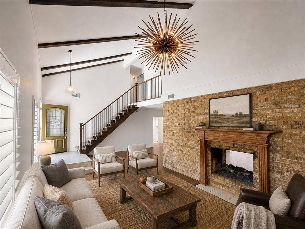3210 Cortez Court W, Irving, TX 75062 Vaulted ceiling with exposed wood beams, full-height masonry fireplace with carved wood mantel, starburst statement chandelier, and staircase featuring a wood handrail with vertical balusters