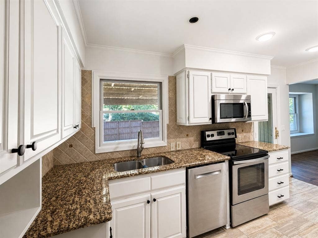 3210 Cortez Court W, Irving, TX 75062 Kitchen featuring white cabinetry, stone-surface countertops, tile backsplash, stainless steel appliances, and a double-basin undermount sink