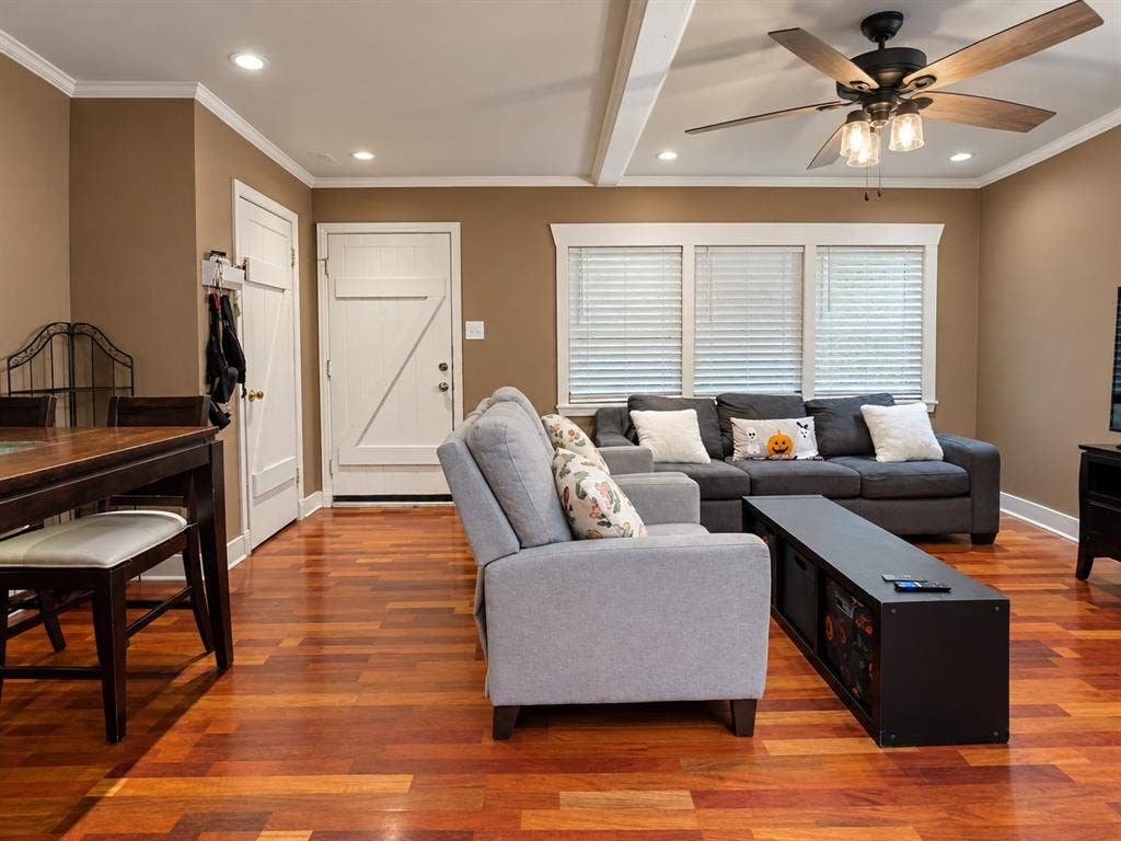 Hardwood flooring, recessed lighting, ceiling fan with integrated light fixture, and three-pane window with horizontal blinds