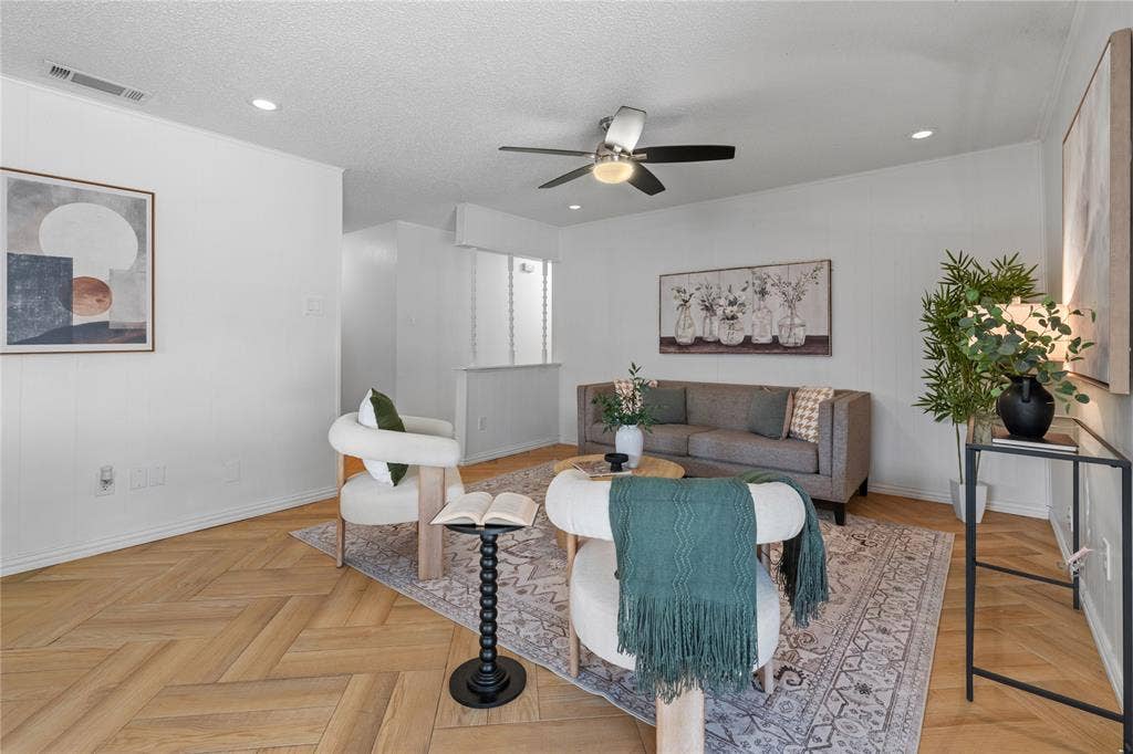 907 Crest Park Drive, Garland, TX 75042 Living area featuring herringbone-pattern wood-finish flooring, recessed lighting, and a ceiling fan with integrated light fixture