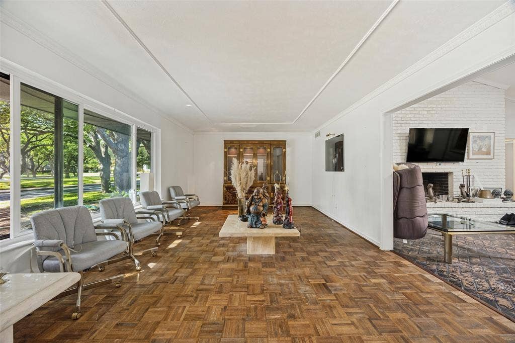7257 Stefani Drive, Dallas, TX 75225 Living Room with inlaid wood floor and large opening to Den.