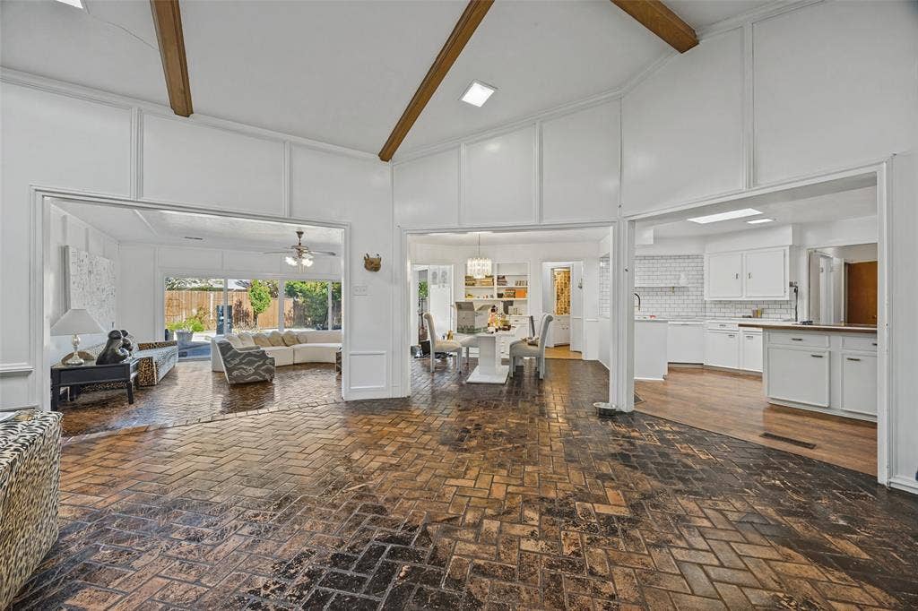 7257 Stefani Drive, Dallas, TX 75225 Den has fireplace, skylight, vaulted & beamed ceiling and opens to Sun Room, Kitchen, and Breakfast Room.