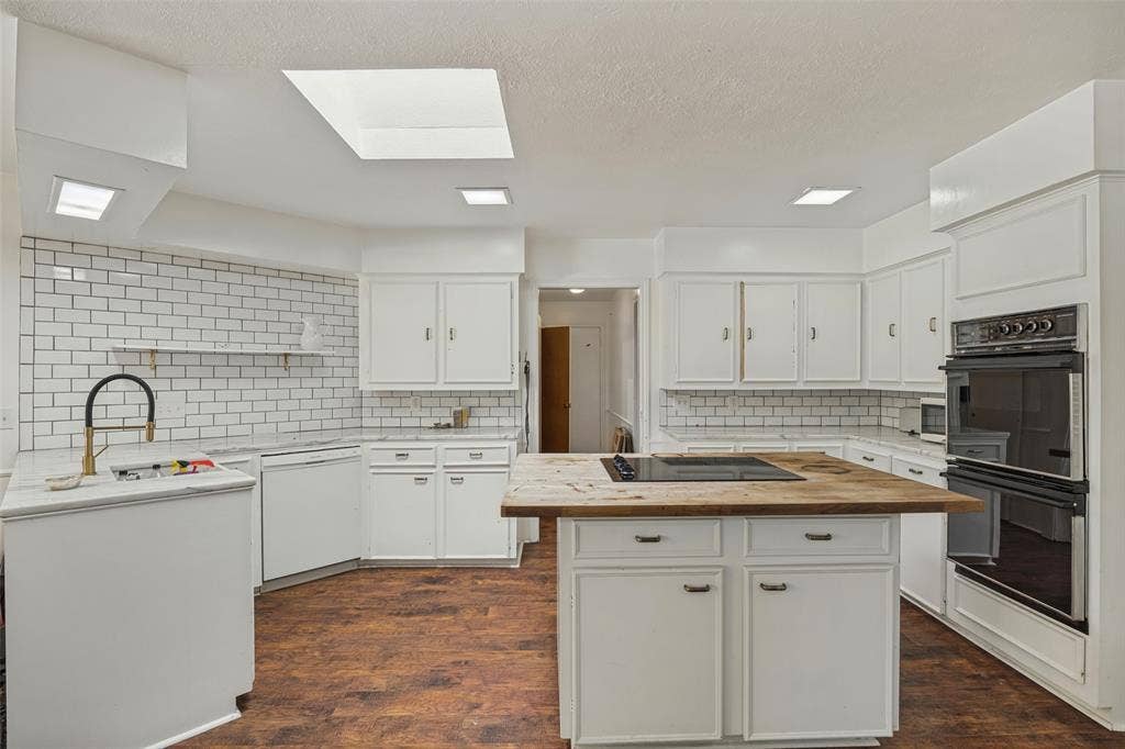 7257 Stefani Drive, Dallas, TX 75225 Kitchen has skylight and center island.