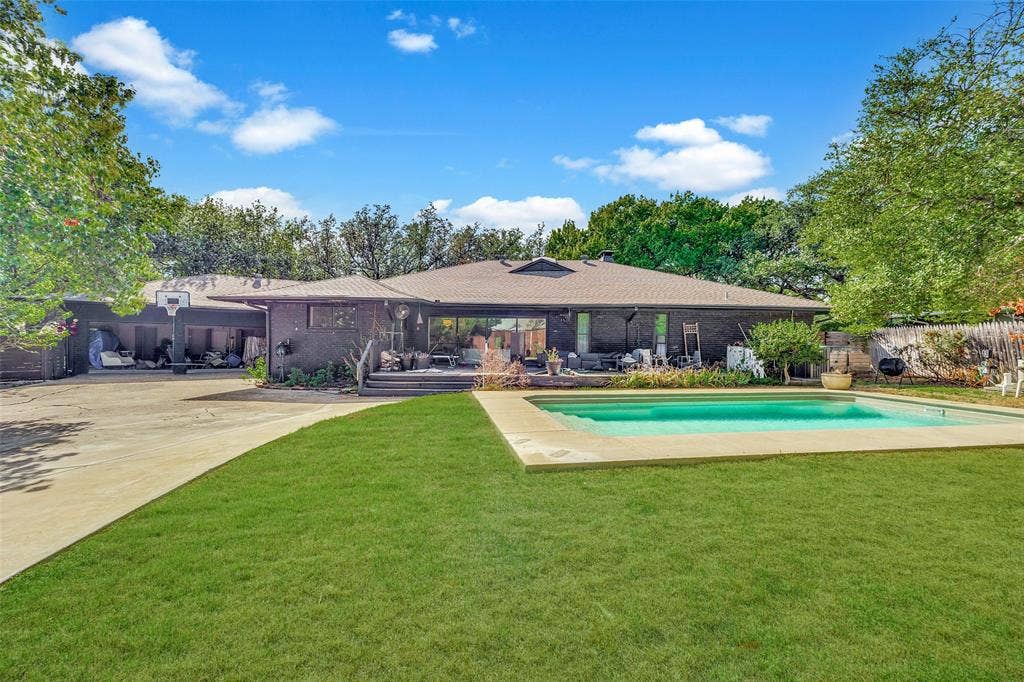 7257 Stefani Drive, Dallas, TX 75225 Pool, grassy yard, 3-car garage, and extra parking.