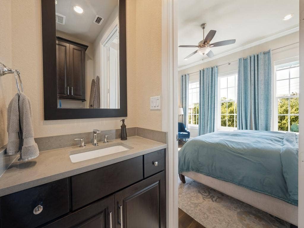 7333 Valley View Lane, #805, Dallas, TX 75240 The Primary Bath Features a Standing Hight Counter, Granite Counters, Framed Mirror and Walk-in Shower