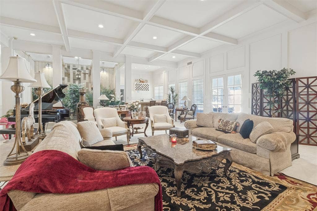 6215 Raintree Court, Dallas, TX 75254 Spacious room featuring a coffered ceiling, recessed lighting, wall molding, and multiple glass-paned doors