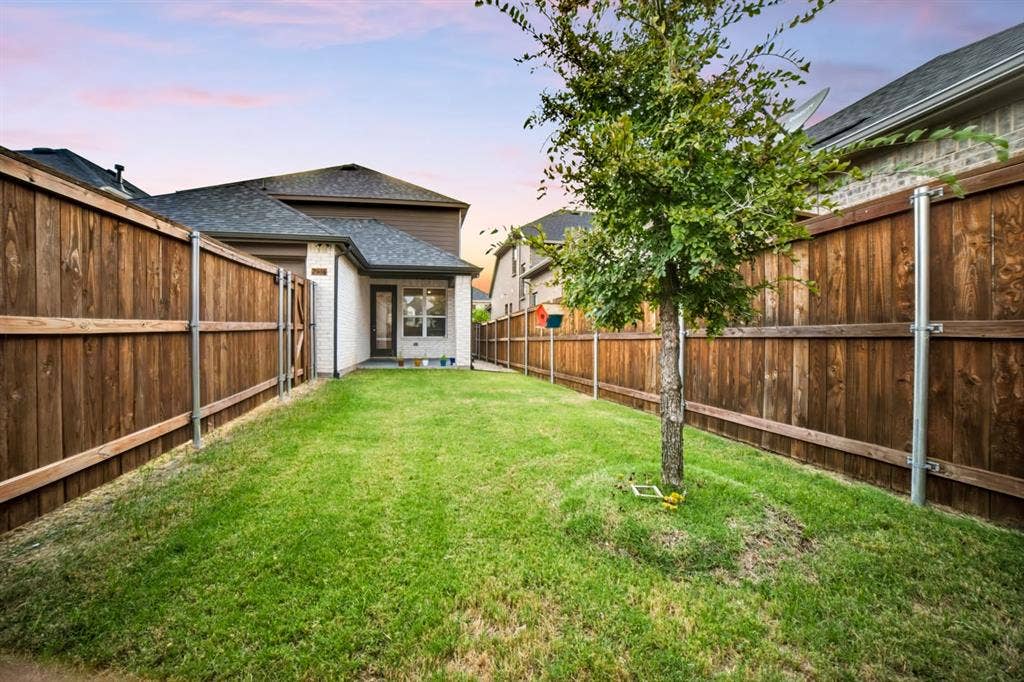 2836 Epping Way, Celina, TX 75009 Generously sized backyard featuring a covered patio, perfect for outdoor entertaining, play, or relaxation.