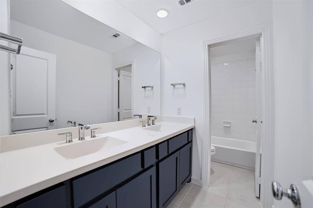 2836 Epping Way, Celina, TX 75009 Upstairs guest bathroom featuring a convenient double-sink vanity.