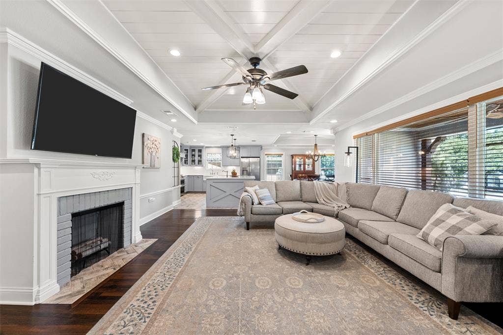 200 Oriental Road, Waco, TX 76710 Vaulted ceiling with cross-beam detailing, fireplace with a custom-painted brick surround, recessed lighting, ceiling fan, and wood-finish flooring