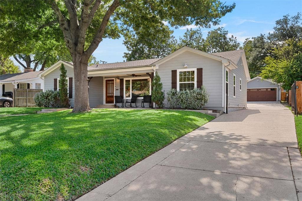 200 Oriental Road, Waco, TX 76710 Single-story exterior featuring lap siding, dark shutter accents, a covered front porch, mature landscaping, and a detached two-car garage
